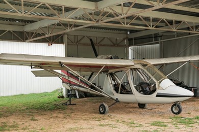 Photo of View of beautiful ultralight airplane in hangar