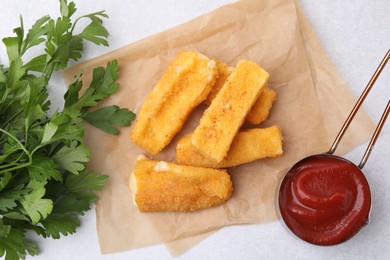 Photo of Tasty fried mozzarella sticks served with parsley and ketchup on white table, flat lay