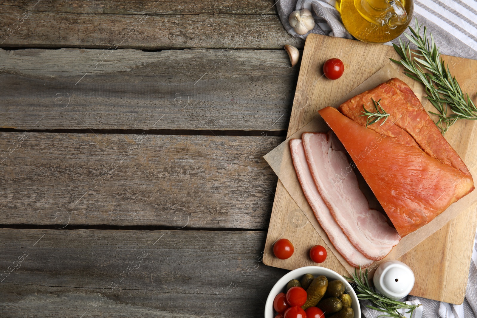 Photo of Flat lay composition with delicious smoked bacon on wooden table, space for text