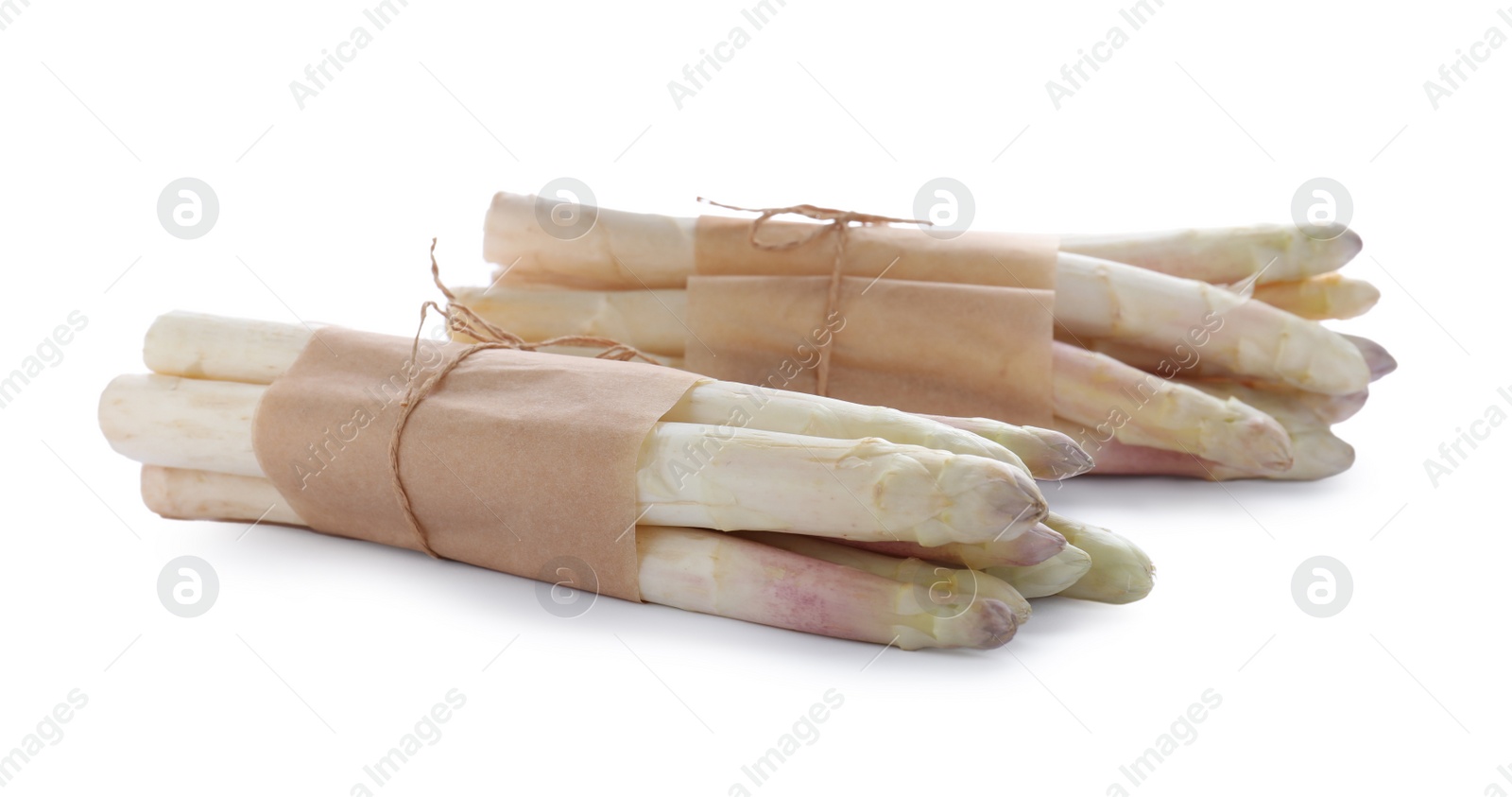 Photo of Bunches of fresh raw asparagus isolated on white