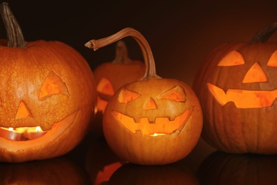 Halloween pumpkin heads. Glowing jack lanterns in dark