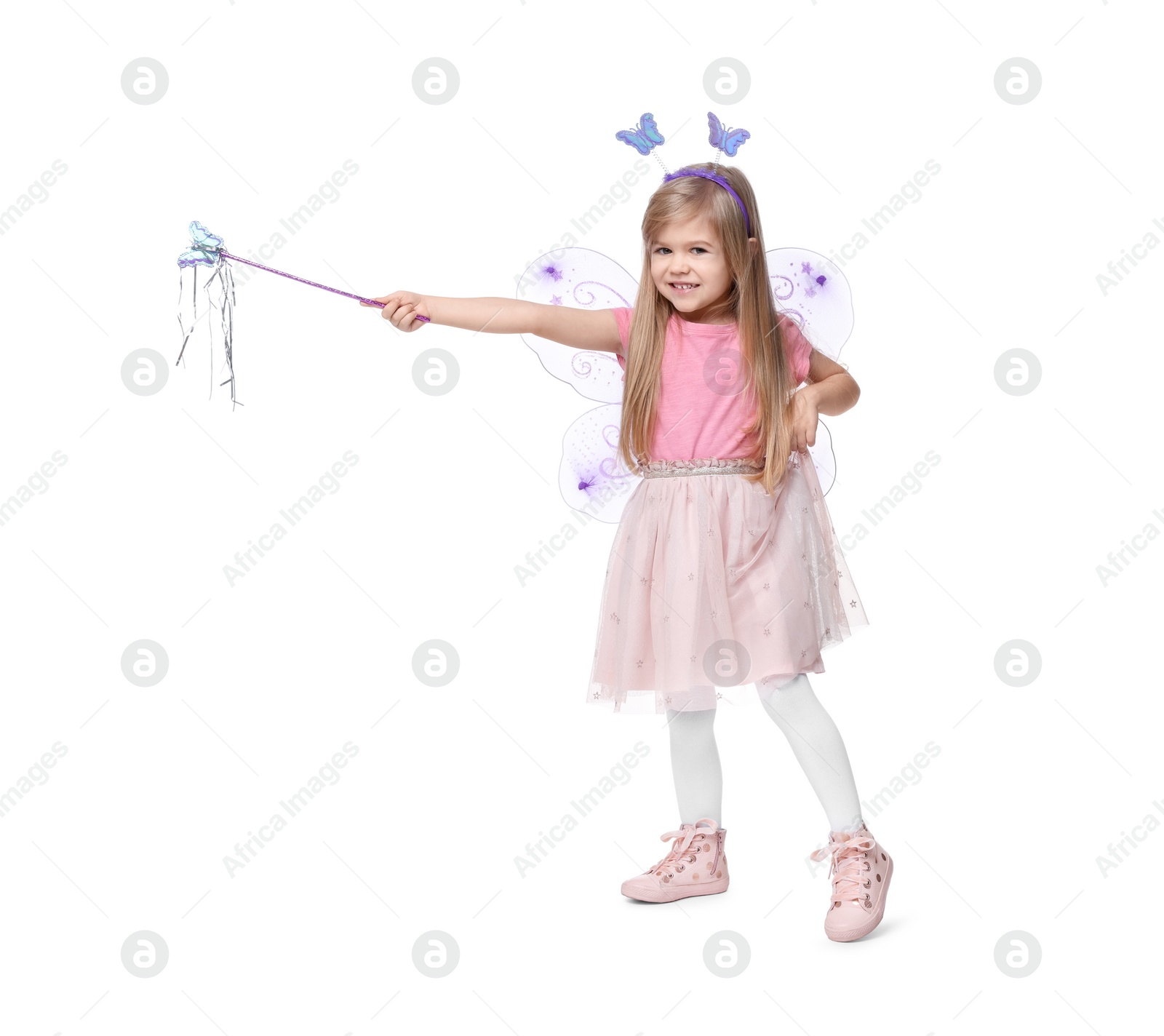 Photo of Cute little girl in fairy costume with violet wings and magic wand on white background