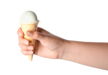 Woman holding delicious ice cream in wafer cone on white background, closeup