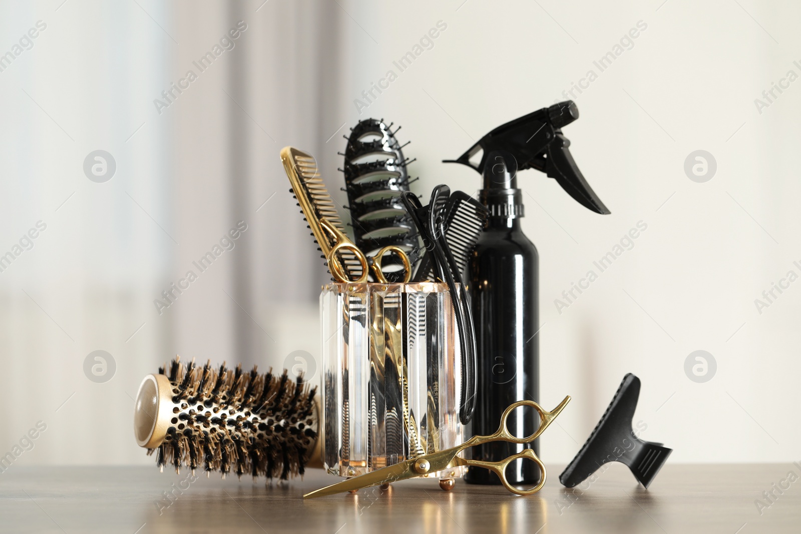 Photo of Set of hairdresser tools on table in salon