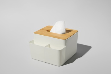 Holder with paper tissues on light grey background