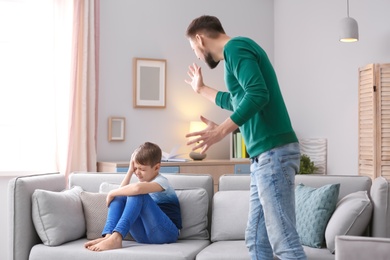 Father arguing with son at home