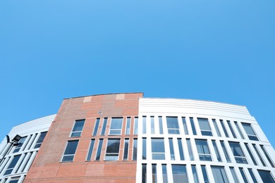Photo of Low angle view of modern building against blue sky