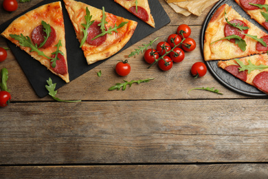 Photo of Flat lay composition with tasty pepperoni pizza on wooden table. Space for text