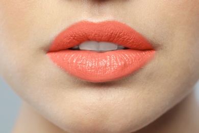 Photo of Young woman wearing beautiful lipstick, closeup view