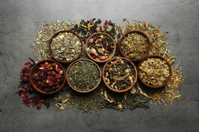 Flat lay composition with different dry teas on grey table