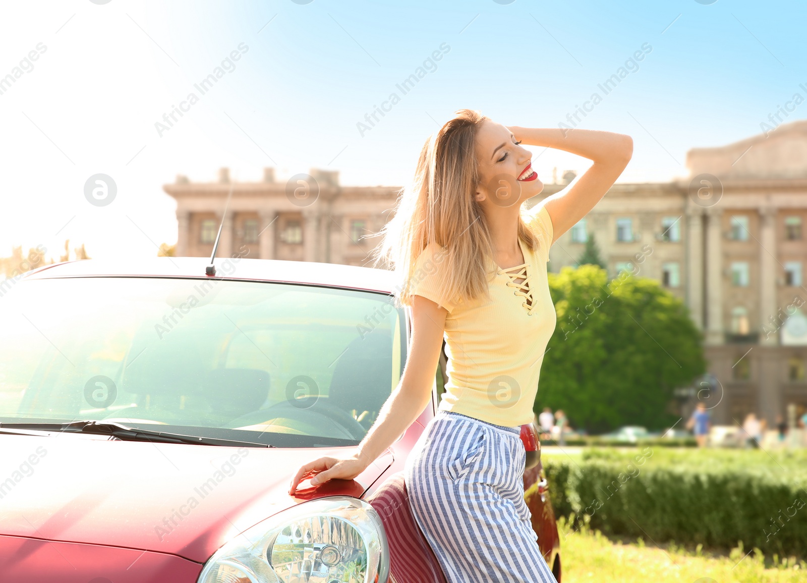 Photo of Young woman near car outdoors on sunny day