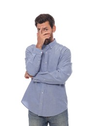 Photo of Embarrassed man covering face with hand on white background