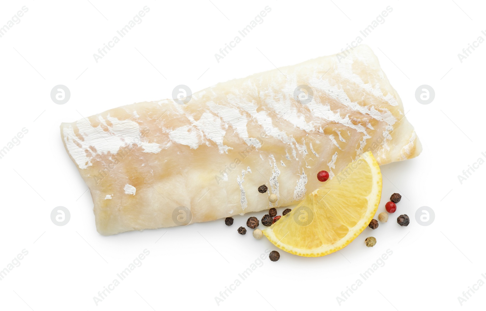 Photo of Fresh raw cod fillet with peppercorns and lemon isolated on white