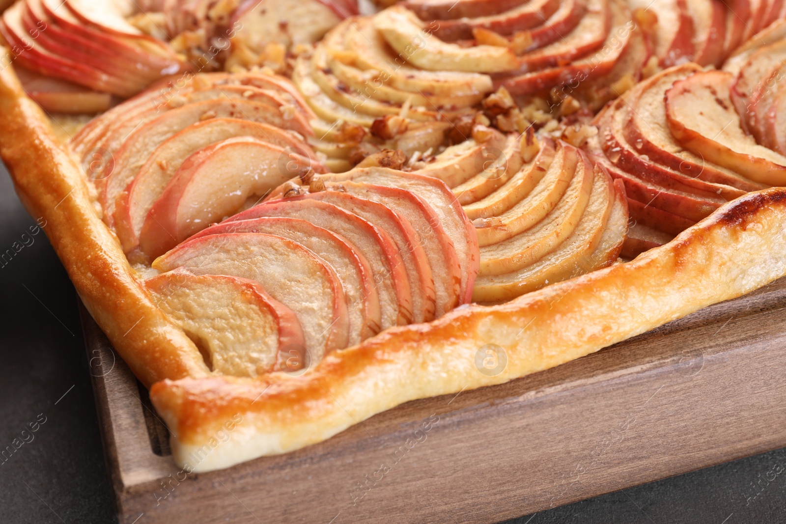 Photo of Tasty apple pie with nuts on table, closeup