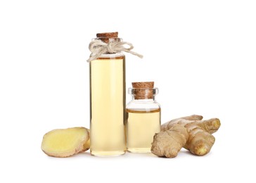 Glass bottles of essential oil and ginger root on white background