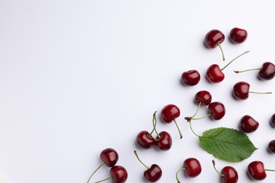 Photo of Many sweet ripe cherries on white background, flat lay. Space for text