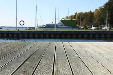 Photo of Beautiful view of wooden terrace near river on sunny day