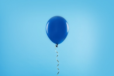 Photo of Bright balloon on color background. Celebration time