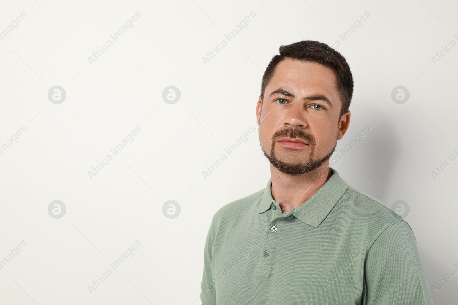 Photo of Portrait of handsome man on light background. Space for text