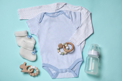 Photo of Flat lay composition with cute baby items on cyan background