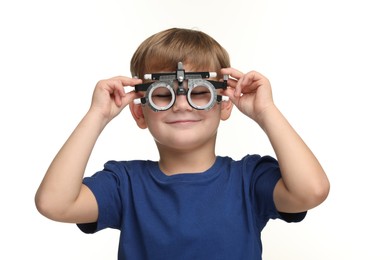 Vision testing. Little boy with trial frame on white background