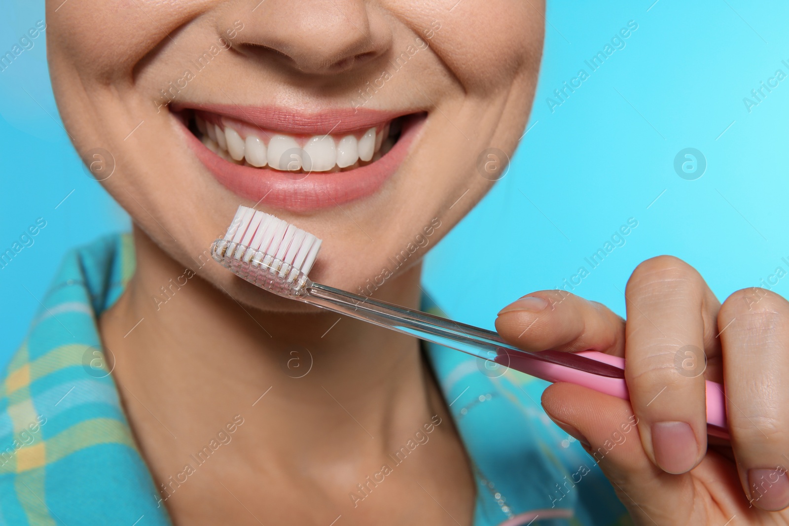 Photo of Woman with toothbrush on color background, closeup