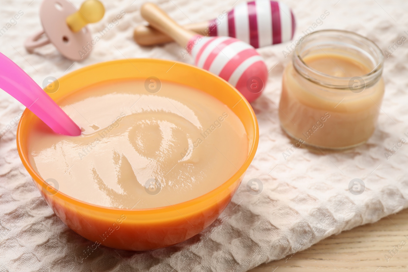 Photo of Bowl of healthy baby food on table, closeup