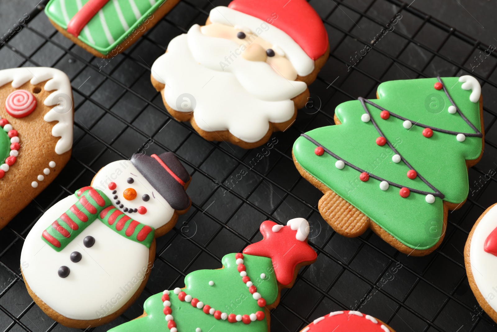 Photo of Delicious Christmas cookies on cooling rack, closeup