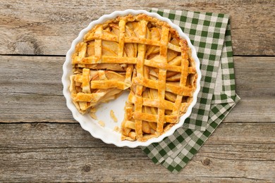 Photo of Tasty homemade quince pie on wooden table, top view