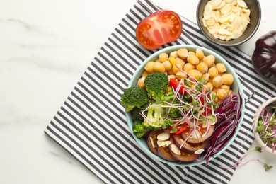 Photo of Delicious vegan bowl with broccoli, red cabbage and chickpeas on white marble table, flat lay. Space for text