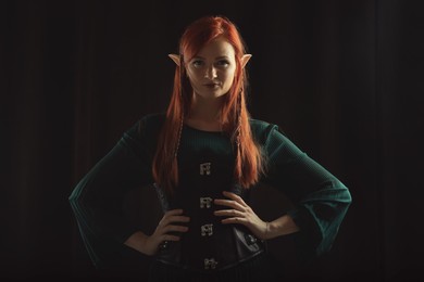 Photo of Beautiful redhead elf girl on black background