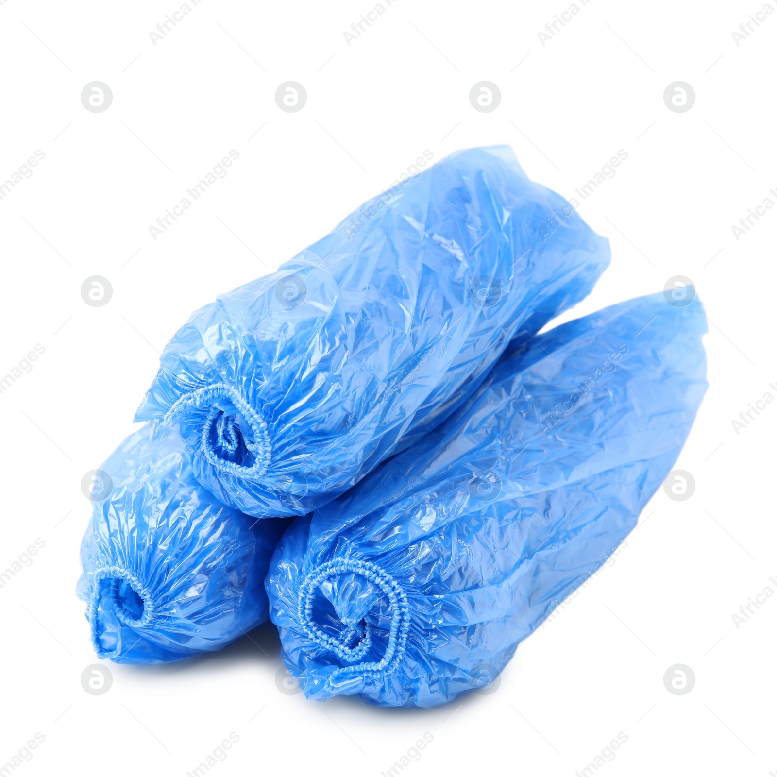 Photo of Rolled blue shoe covers isolated on white