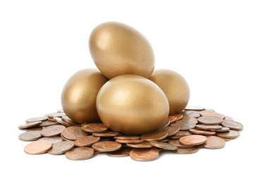 Photo of Gold eggs with coins on white background