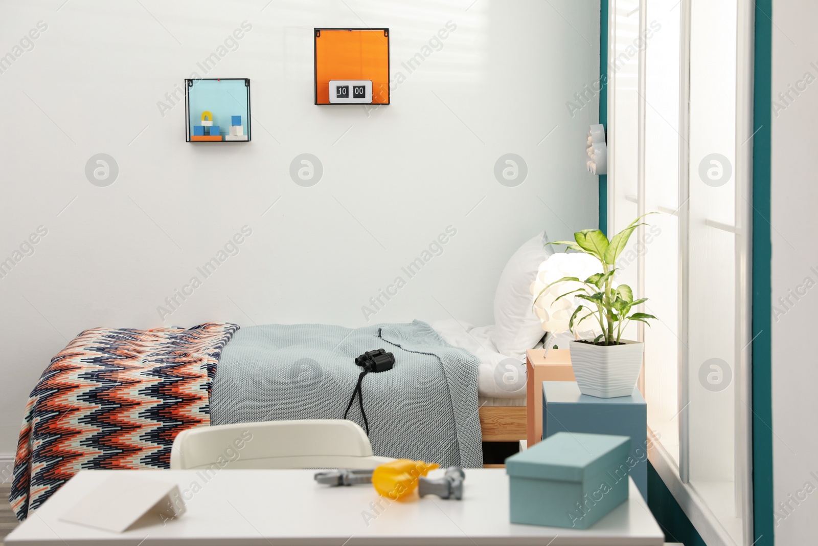 Photo of Modern child room interior with desk and comfortable bed
