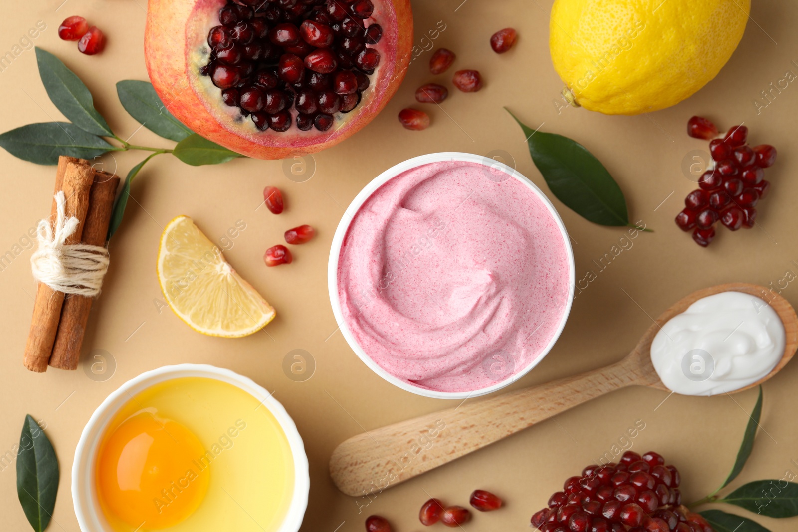 Photo of Flat lay composition with natural homemade mask, pomegranate and ingredients on beige background