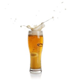 Beer splashing out of glass on white background