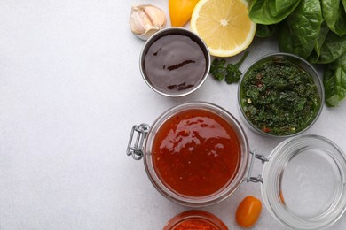 Photo of Different marinades and products on light table, flat lay. Space for text