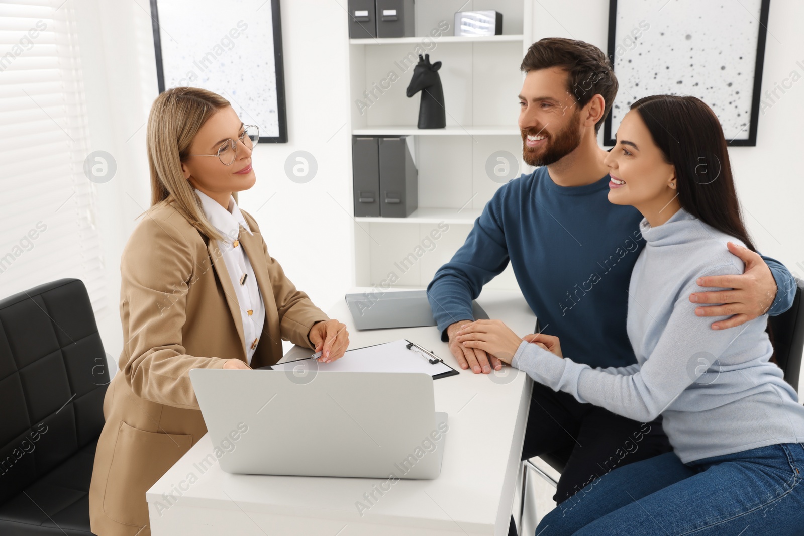 Photo of Real estate agent consulting couple in office