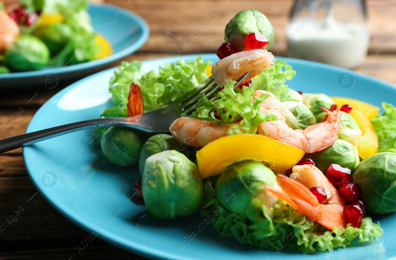 Photo of Tasty salad with Brussels sprouts served on table, closeup