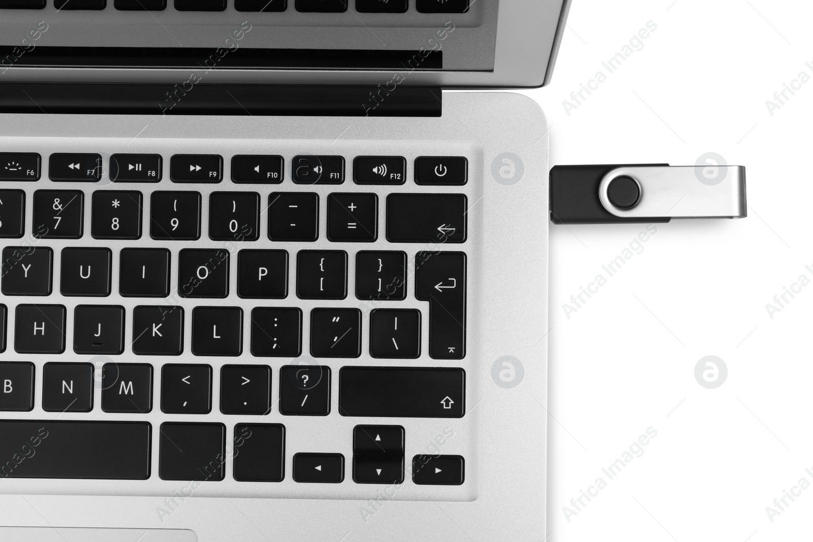 Photo of Modern usb flash drive attached into laptop on white background, top view