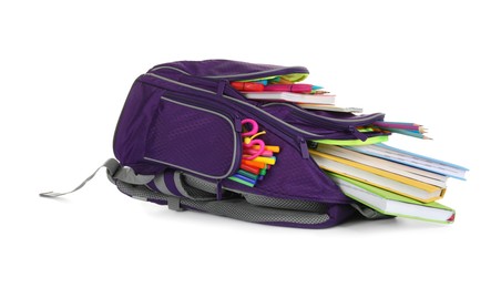 Purple backpack with different school supplies isolated on white