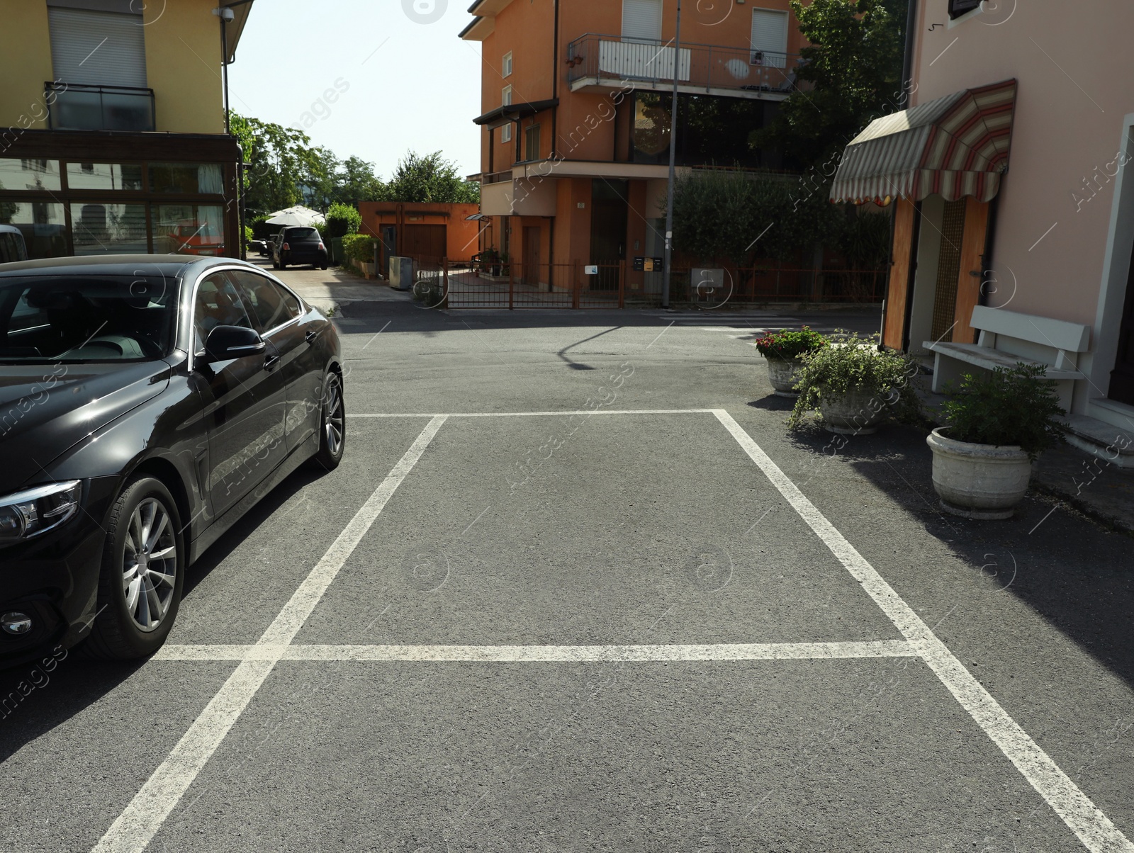 Photo of Beautiful street with parking lot and buildings on sunny day