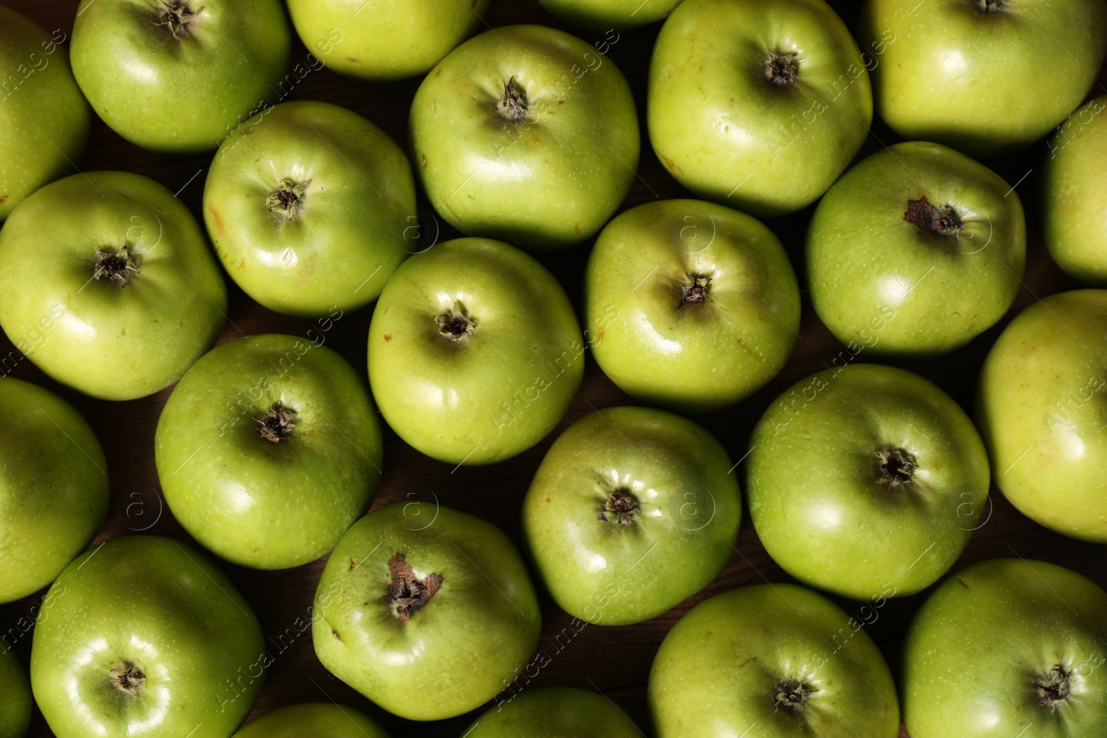 Photo of Fresh ripe green apples on wooden table, top view