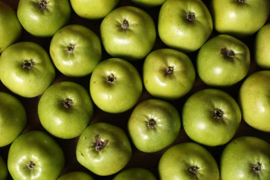 Photo of Fresh ripe green apples on wooden table, top view