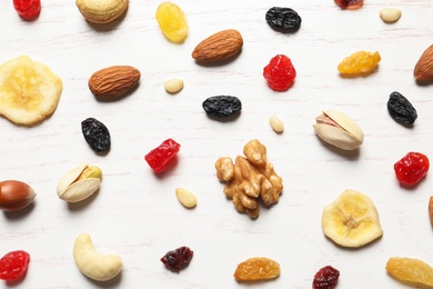 Photo of Flat lay composition of different dried fruits and nuts on wooden background
