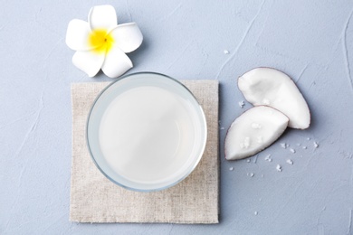 Glass of coconut water on grey background