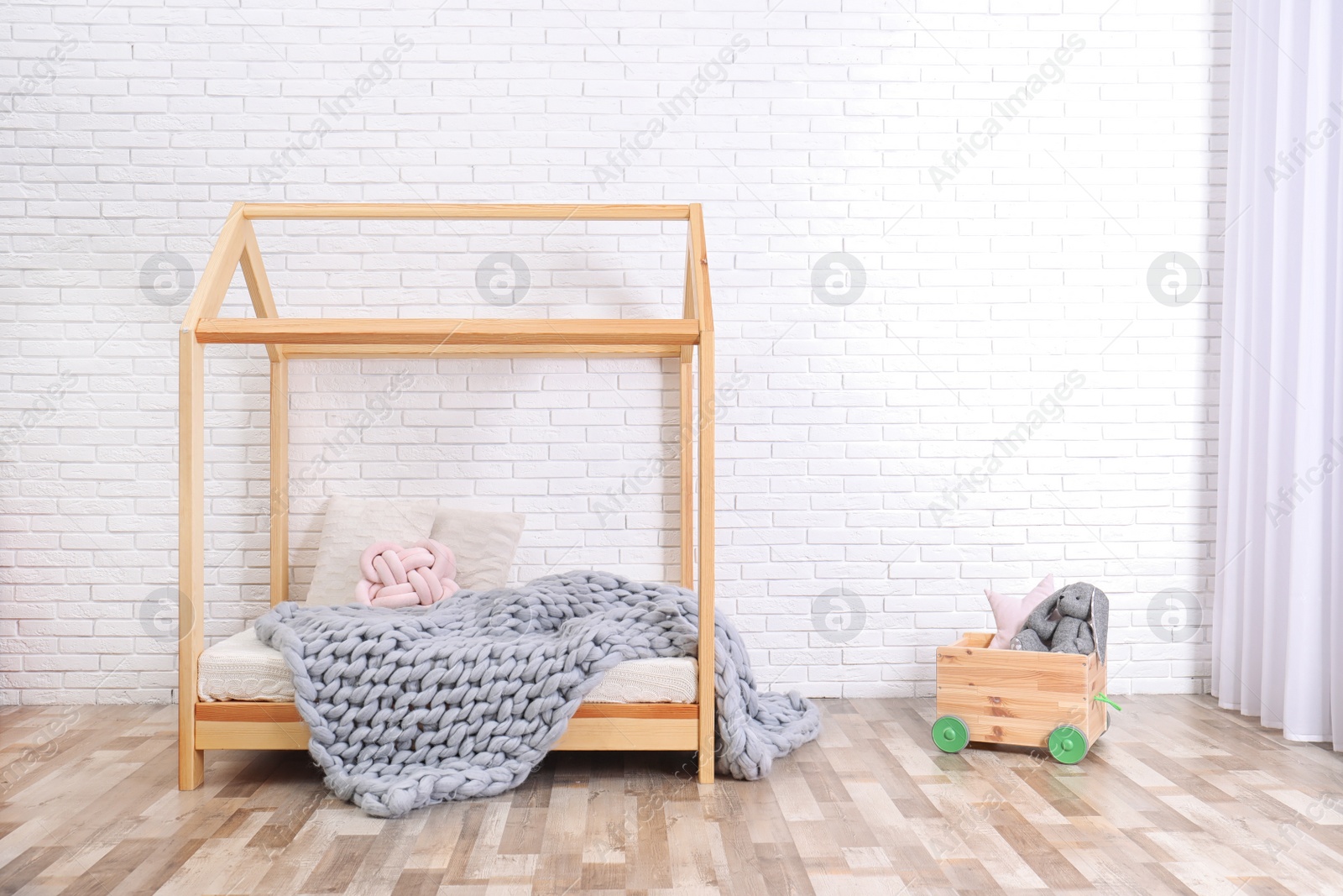 Photo of Stylish child room interior with house bed. Space for text