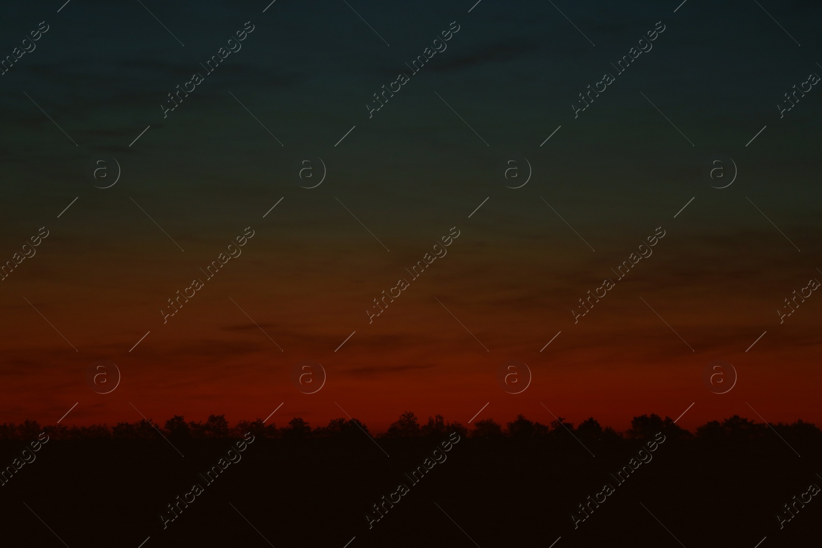 Photo of Picturesque view of beautiful sky lit by setting sun