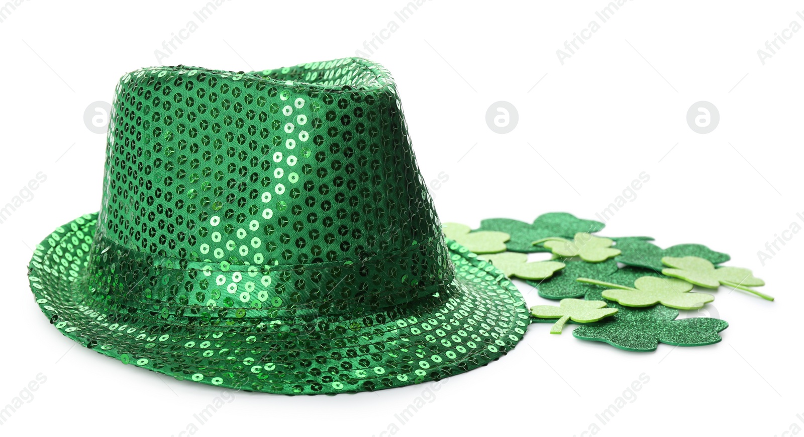 Photo of Leprechaun's hat and decorative clover leaves on white background. St. Patrick's day celebration