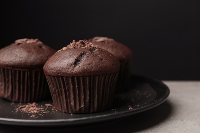 Delicious cupcakes with chocolate crumbles on grey table, closeup